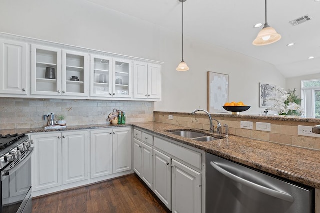 6706 Fort Davis Cv Unit B, Austin, TX 78731 - kitchen with appliances with stainless steel finishes, decorative backsplash, dark wood-style flooring, white cabinets, and lofted ceiling