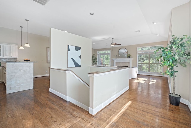 6706 Fort Davis Cv Unit B, Austin, TX 78731 - kitchen featuring wood finished floors, a fireplace, ceiling fan, decorative light fixtures, and recessed lighting