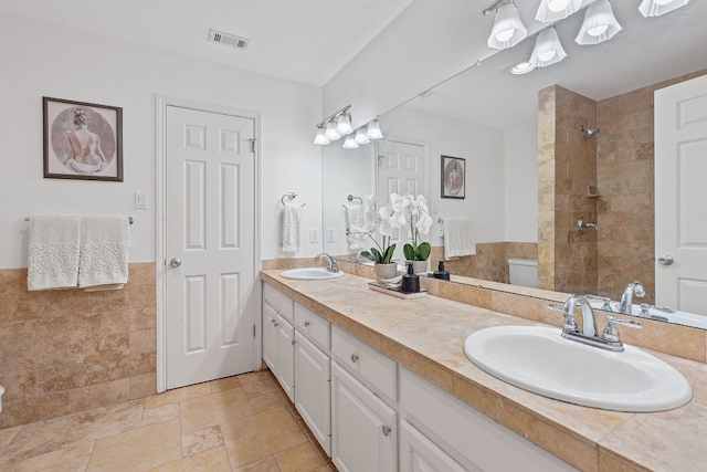 6706 Fort Davis Cv Unit B, Austin, TX 78731 - bathroom with double vanity, tiled shower, and stone finish floors