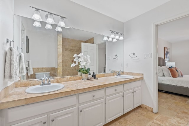 6706 Fort Davis Cv Unit B, Austin, TX 78731 - bathroom featuring double vanity, ensuite bathroom, and stone finish flooring