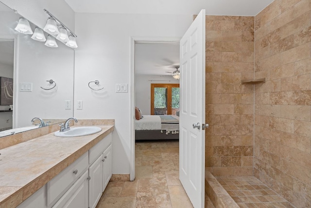 6706 Fort Davis Cv Unit B, Austin, TX 78731 - ensuite bathroom with vanity, stone finish floors, a ceiling fan, and a tile shower