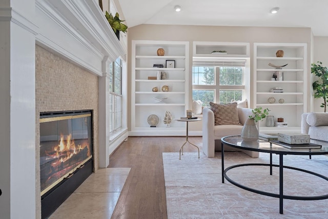 6706 Fort Davis Cv Unit B, Austin, TX 78731 - living room featuring a glass covered fireplace, built in shelves, and wood finished floors