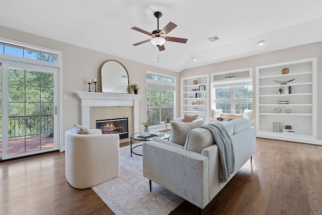 6706 Fort Davis Cv Unit B, Austin, TX 78731 - living area with ceiling fan, wood finished floors, built in shelves, a glass covered fireplace, and vaulted ceiling