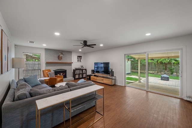 10207 Ray Ave, Austin, TX 78758 - living area with a fireplace, recessed lighting, ceiling fan, and wood finished floors