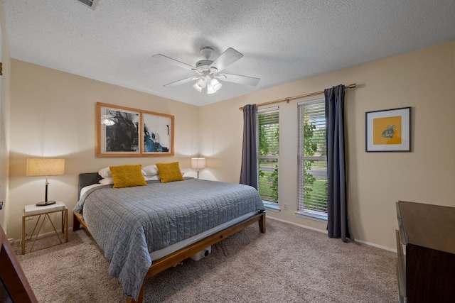 10207 Ray Ave, Austin, TX 78758 - bedroom featuring light carpet, a textured ceiling, ceiling fan, and baseboards