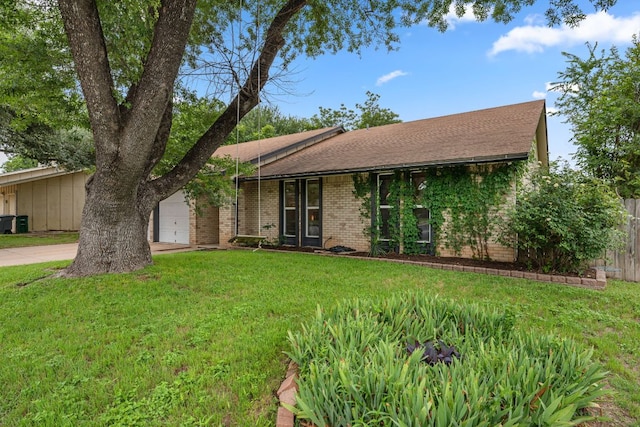 10207 Ray Ave, Austin, TX 78758 - view of front of house with concrete driveway, brick siding, and an attached garage
