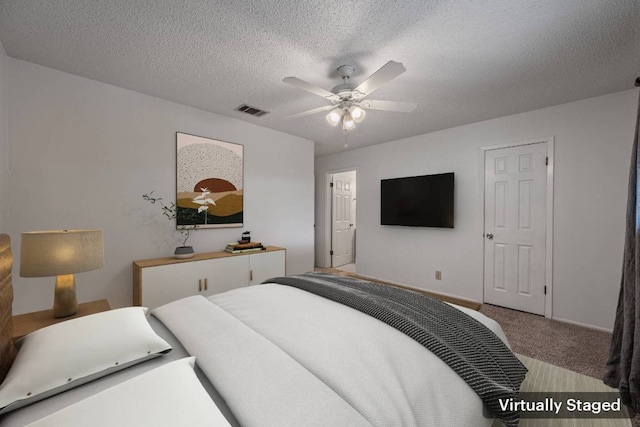 10207 Ray Ave, Austin, TX 78758 - carpeted bedroom featuring a textured ceiling, baseboards, and a ceiling fan