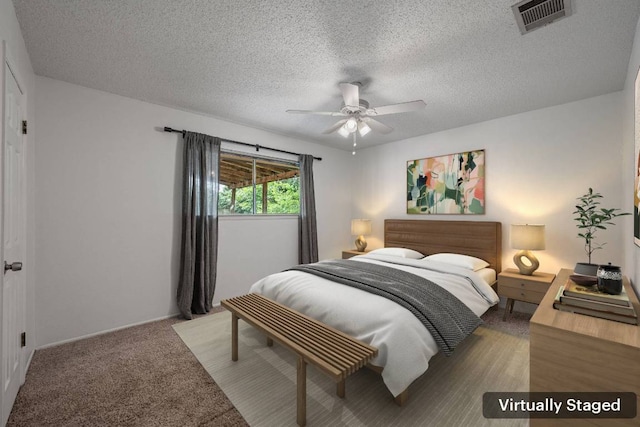 10207 Ray Ave, Austin, TX 78758 - bedroom with a textured ceiling, carpet, baseboards, and ceiling fan