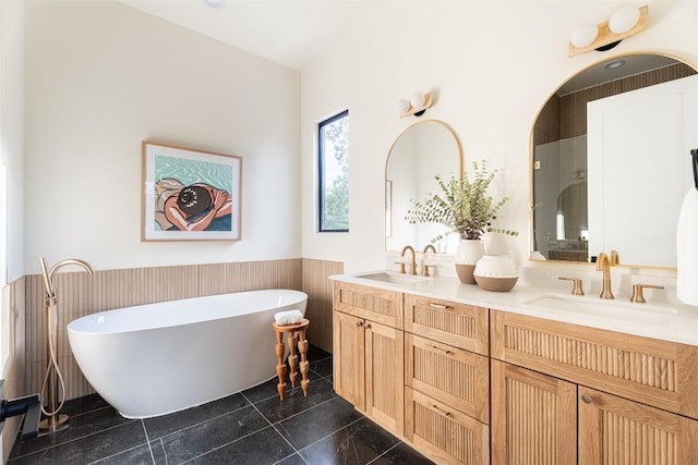 2301 Canterbury, Austin, TX 78702 - full bath featuring wainscoting, double vanity, and a freestanding tub