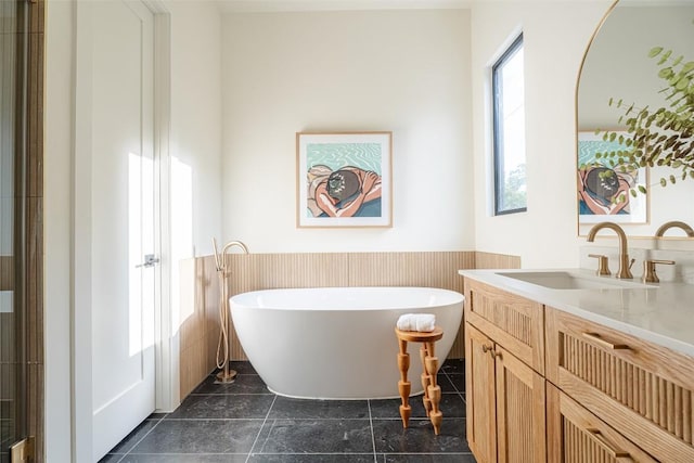 2301 Canterbury, Austin, TX 78702 - full bath featuring wainscoting, a freestanding tub, vanity, and tile walls