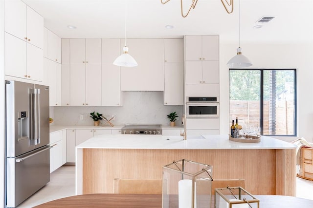 2301 Canterbury, Austin, TX 78702 - kitchen featuring high end fridge, a sink, tasteful backsplash, light countertops, and white cabinetry