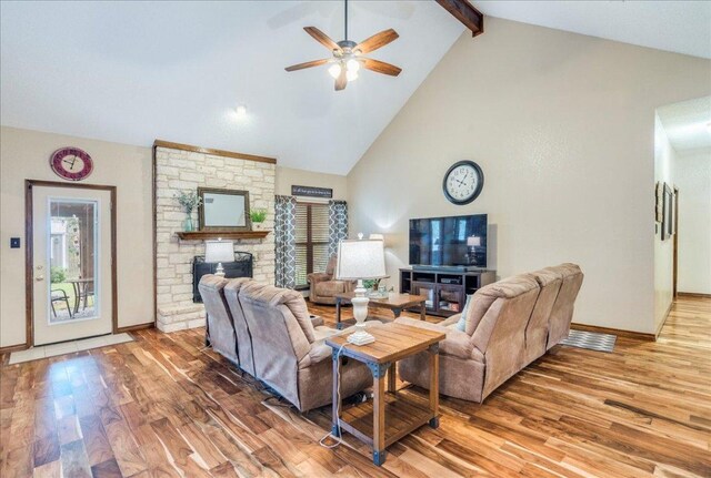 336 Primrose Dr, Kyle, TX 78640 - living area featuring a fireplace, light wood-type flooring, a ceiling fan, beamed ceiling, and baseboards
