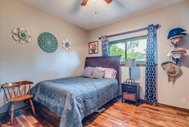 336 Primrose Dr, Kyle, TX 78640 - bedroom with wood finished floors, a textured ceiling, and ceiling fan