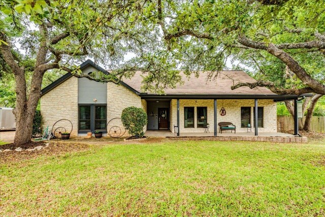 336 Primrose Dr, Kyle, TX 78640 - back of house with stone siding and a patio area