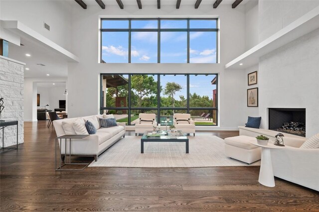 9517 Veletta Pl, Austin, TX 78735 - living area featuring a towering ceiling, a fireplace, beam ceiling, wood finished floors, and recessed lighting