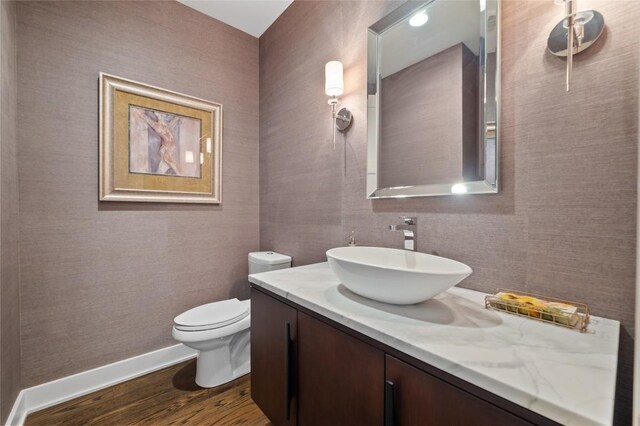9517 Veletta Pl, Austin, TX 78735 - half bath featuring baseboards, vanity, wood finished floors, and toilet
