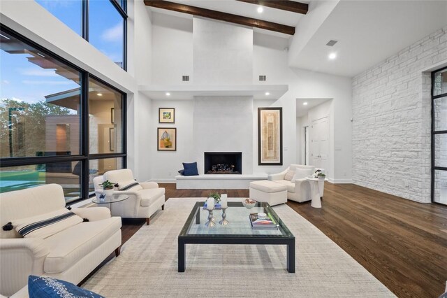 9517 Veletta Pl, Austin, TX 78735 - living room with high vaulted ceiling, wood finished floors, beam ceiling, healthy amount of natural light, and a fireplace