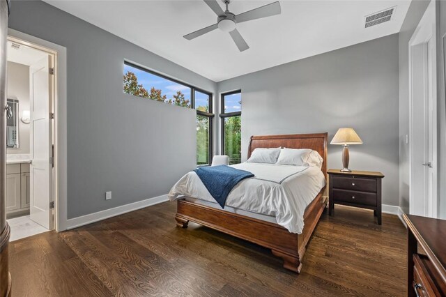 9517 Veletta Pl, Austin, TX 78735 - bedroom featuring wood finished floors, baseboards, and connected bathroom