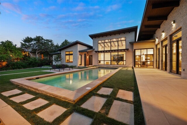 9517 Veletta Pl, Austin, TX 78735 - pool at dusk with a patio area and an outdoor pool