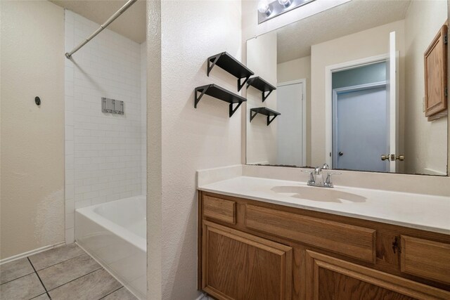 4700 Fallenash Dr, Austin, TX 78725 - bathroom featuring vanity, tile patterned flooring, bathing tub / shower combination, and a textured wall