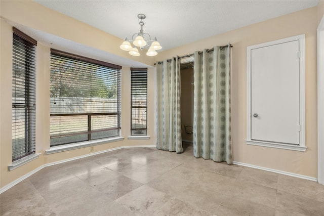 4700 Fallenash Dr, Austin, TX 78725 - tiled spare room featuring a chandelier and baseboards