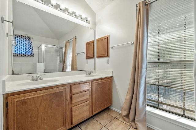 4700 Fallenash Dr, Austin, TX 78725 - bathroom with lofted ceiling, an enclosed shower, double vanity, and tile patterned flooring