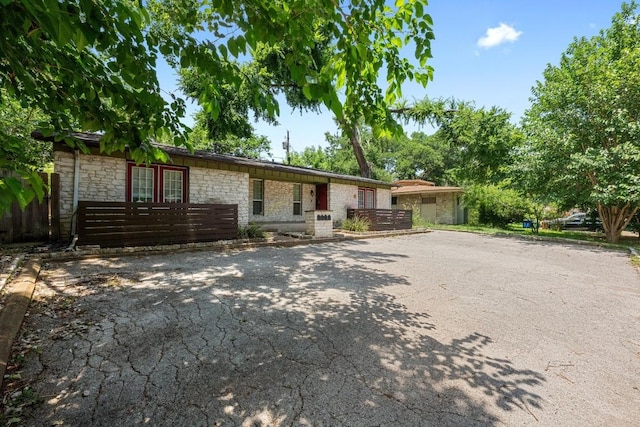 3102 Glen Ora St Unit 102, Austin, TX 78704 - single story home featuring stone siding and driveway