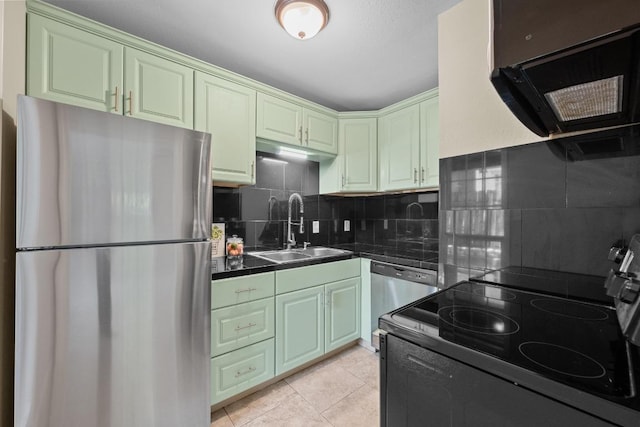 3102 Glen Ora St Unit 102, Austin, TX 78704 - kitchen with appliances with stainless steel finishes, dark countertops, decorative backsplash, and light tile patterned floors