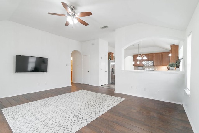 1310 Rainbow Parke Dr, Round Rock, TX 78665 - living area with lofted ceiling, arched walkways, ceiling fan, dark wood-style floors, and plenty of natural light