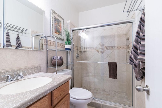 1310 Rainbow Parke Dr, Round Rock, TX 78665 - bathroom with a shower stall, vanity, and tile walls
