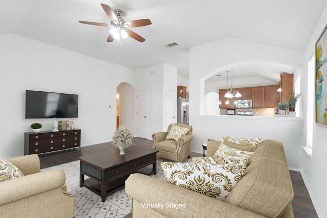 1310 Rainbow Parke Dr, Round Rock, TX 78665 - living area with arched walkways, vaulted ceiling, wood finished floors, ceiling fan, and baseboards