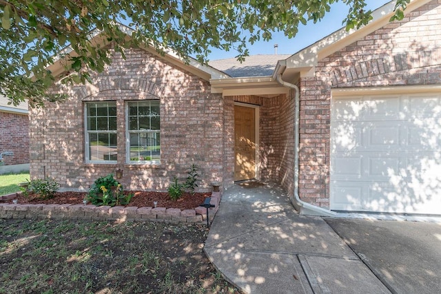1310 Rainbow Parke Dr, Round Rock, TX 78665 - doorway to property featuring brick siding, a garage, and a shingled roof