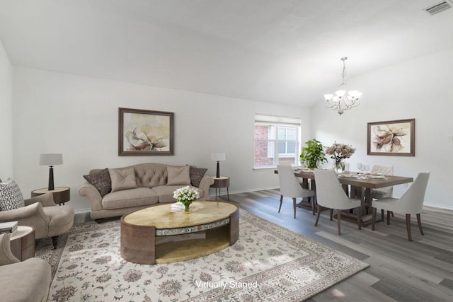 1310 Rainbow Parke Dr, Round Rock, TX 78665 - living area with a chandelier, wood finished floors, baseboards, and vaulted ceiling