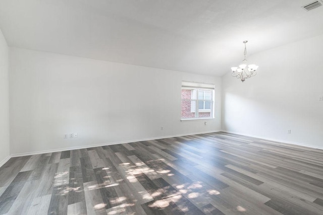 1310 Rainbow Parke Dr, Round Rock, TX 78665 - empty room featuring a chandelier, dark wood-type flooring, vaulted ceiling, and baseboards