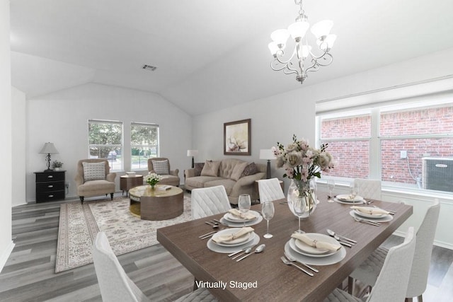 1310 Rainbow Parke Dr, Round Rock, TX 78665 - dining area with wood finished floors, a chandelier, and lofted ceiling