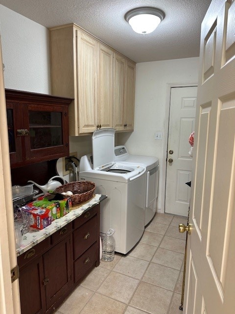 145 Turkey Run, Meadowlakes, TX 78654 - laundry area featuring cabinet space, separate washer and dryer, a textured ceiling, and light tile patterned flooring