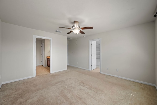 5406 Traviston Dr, Austin, TX 78738 - unfurnished bedroom with a walk in closet, light colored carpet, baseboards, a closet, and connected bathroom