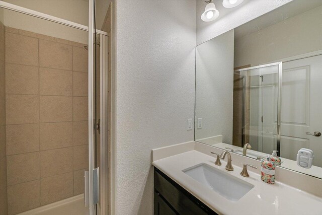 9424 Sawyer Fay Ln, Austin, TX 78748 - full bathroom with a stall shower, a textured wall, and vanity