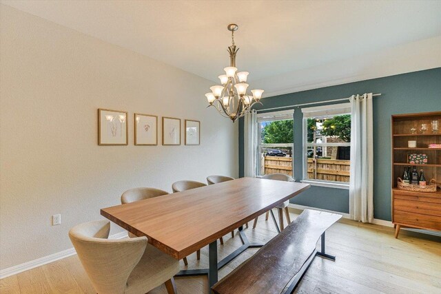 9424 Sawyer Fay Ln, Austin, TX 78748 - dining area with a chandelier, light wood-type flooring, and baseboards