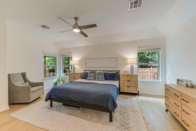 9424 Sawyer Fay Ln, Austin, TX 78748 - bedroom with light wood-type flooring, multiple windows, vaulted ceiling, and baseboards