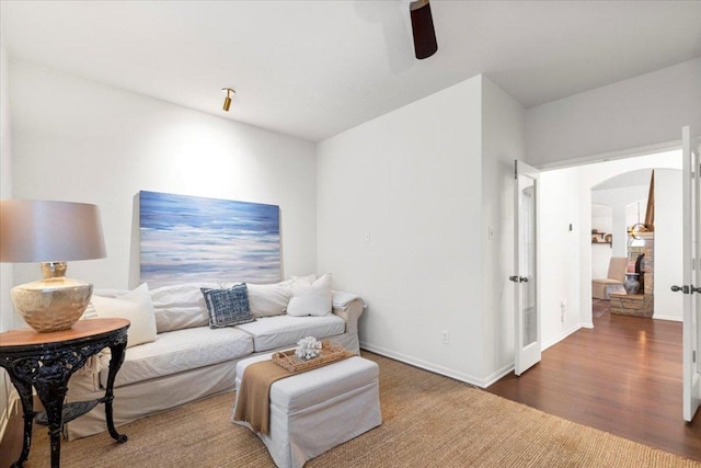 12501 Bright Sky Overlook, Austin, TX 78732 - living area featuring arched walkways, a ceiling fan, and wood finished floors