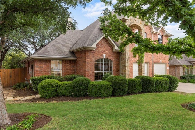 12501 Bright Sky Overlook, Austin, TX 78732 - view of front facade featuring an attached garage, concrete driveway, brick siding, and a shingled roof