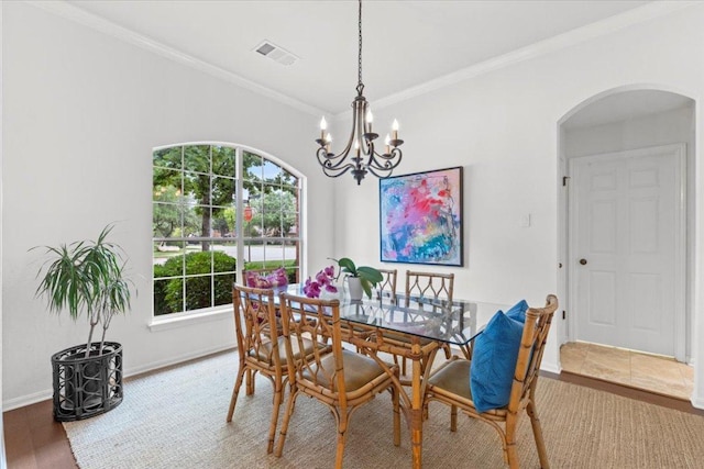 12501 Bright Sky Overlook, Austin, TX 78732 - dining area featuring arched walkways, a chandelier, and ornamental molding