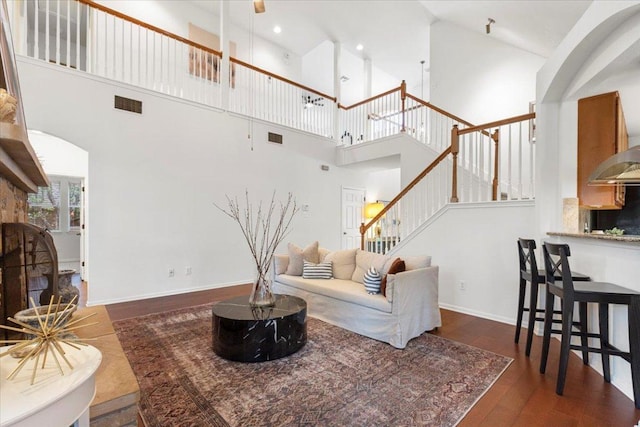12501 Bright Sky Overlook, Austin, TX 78732 - living room featuring a high ceiling, wood finished floors, stairs, and arched walkways