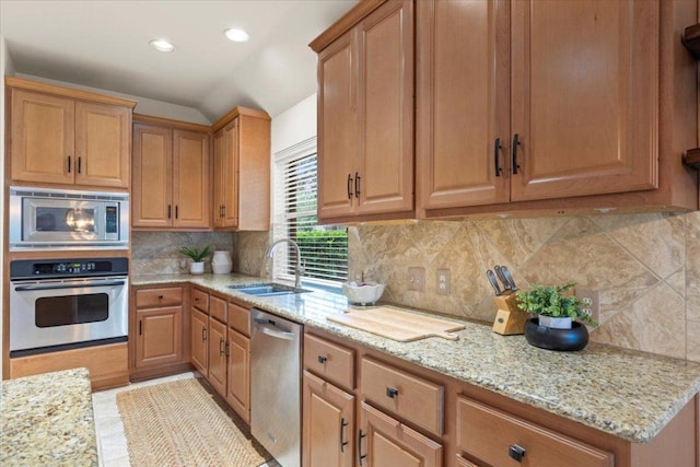 12501 Bright Sky Overlook, Austin, TX 78732 - kitchen with appliances with stainless steel finishes, light stone countertops, backsplash, and recessed lighting