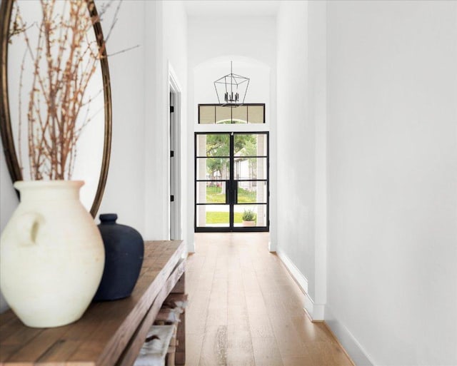482 Running Bird Rd, Austin, TX 78737 - hallway featuring a chandelier, light wood-type flooring, and baseboards