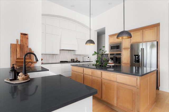 482 Running Bird Rd, Austin, TX 78737 - kitchen with custom range hood, stainless steel appliances, dark countertops, and tasteful backsplash