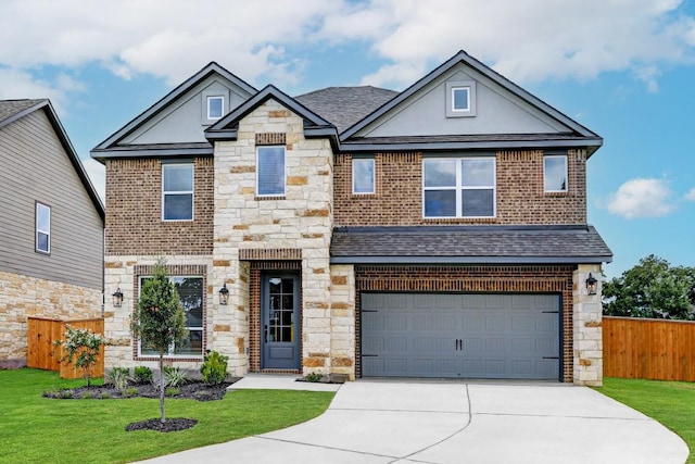 120 Periwinkle Ln, Bastrop, TX 78602 - view of front of home with stone siding, a garage, driveway, a shingled roof, and brick siding