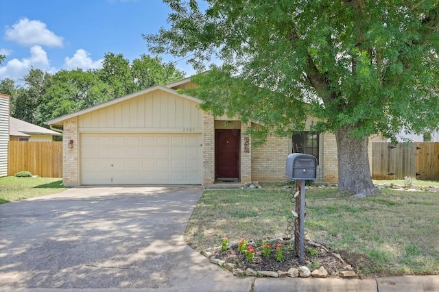 3921 Leafield Dr, Austin, TX 78749 - view of front of property featuring brick siding, an attached garage, and driveway