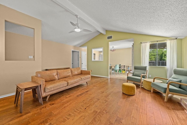 3921 Leafield Dr, Austin, TX 78749 - living room with light wood-type flooring, ceiling fan, a textured ceiling, and baseboards